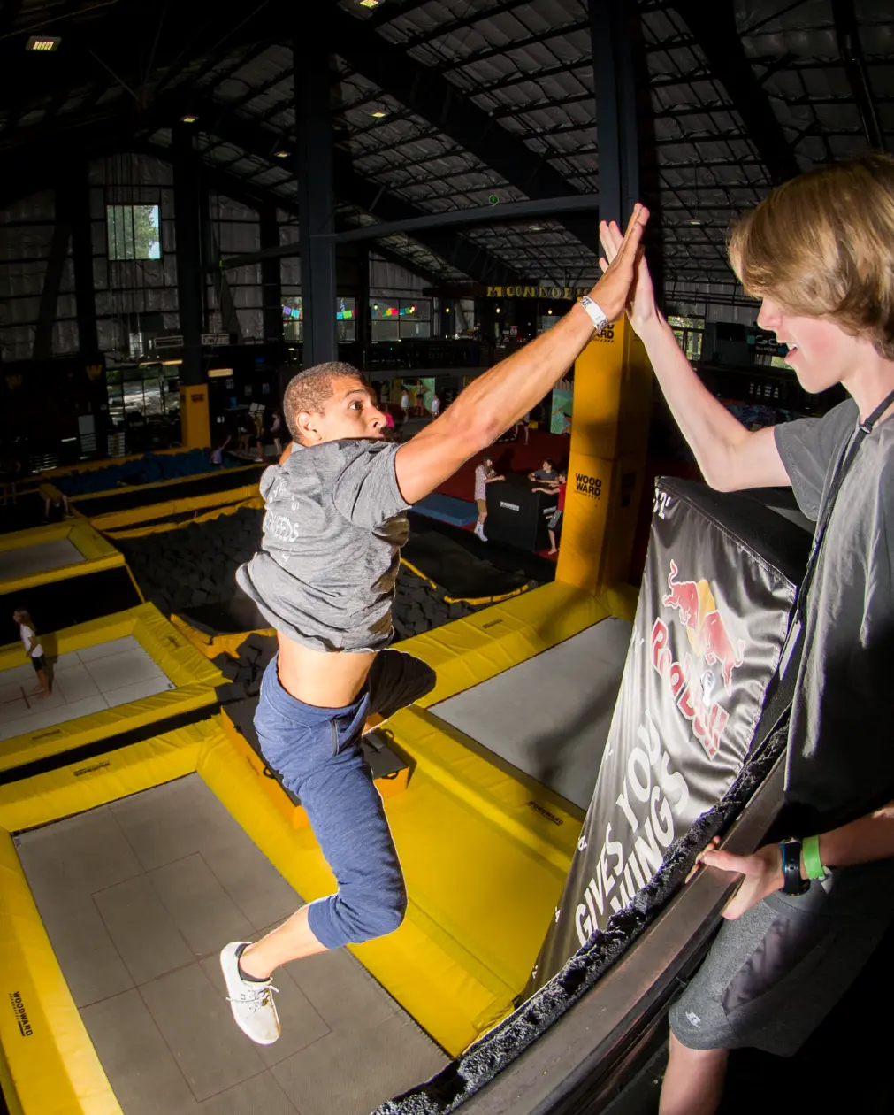 Coach giving an athlete a high five on trampoline
