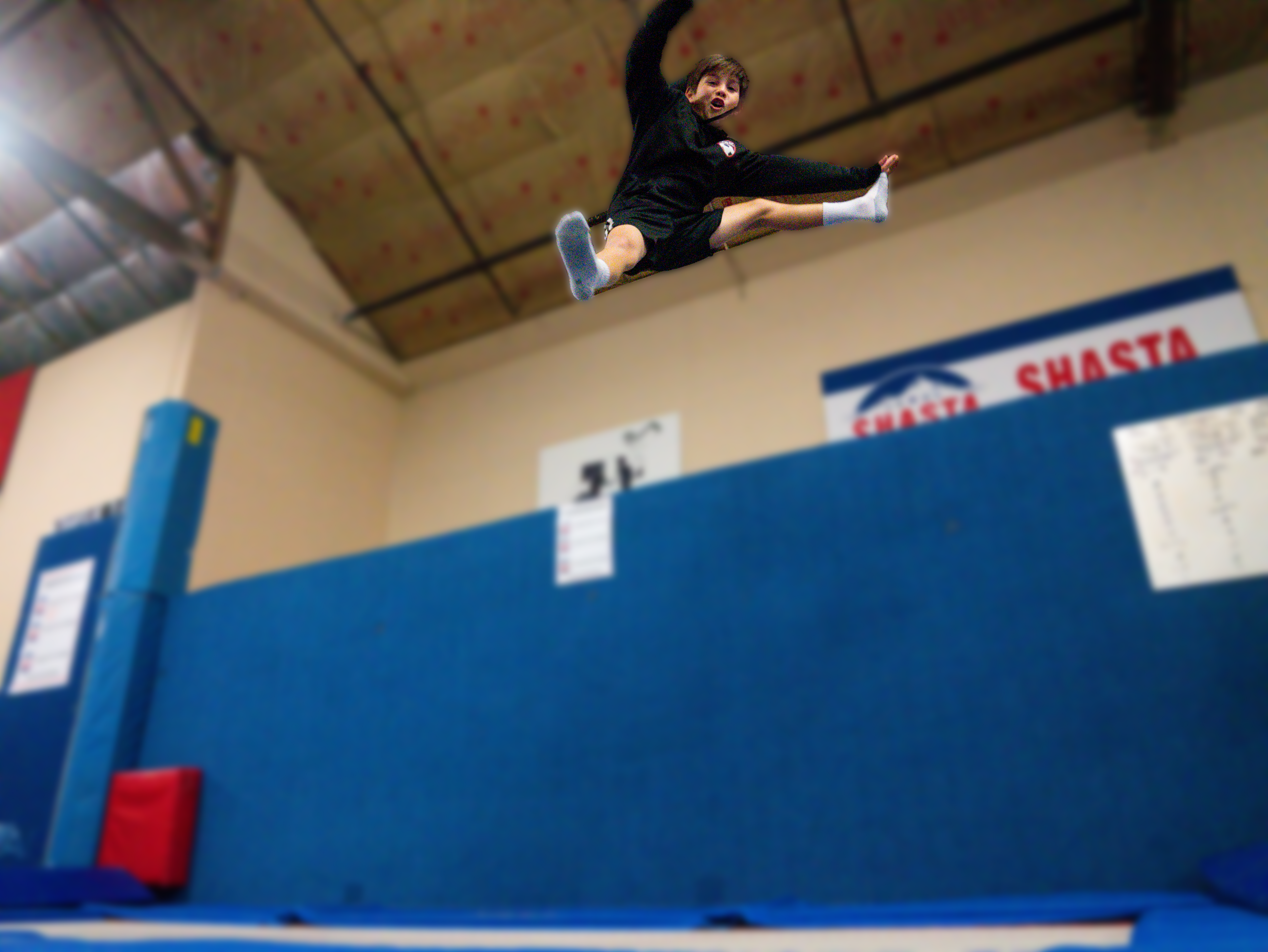 Athlete performing a flying kick on trampoline
