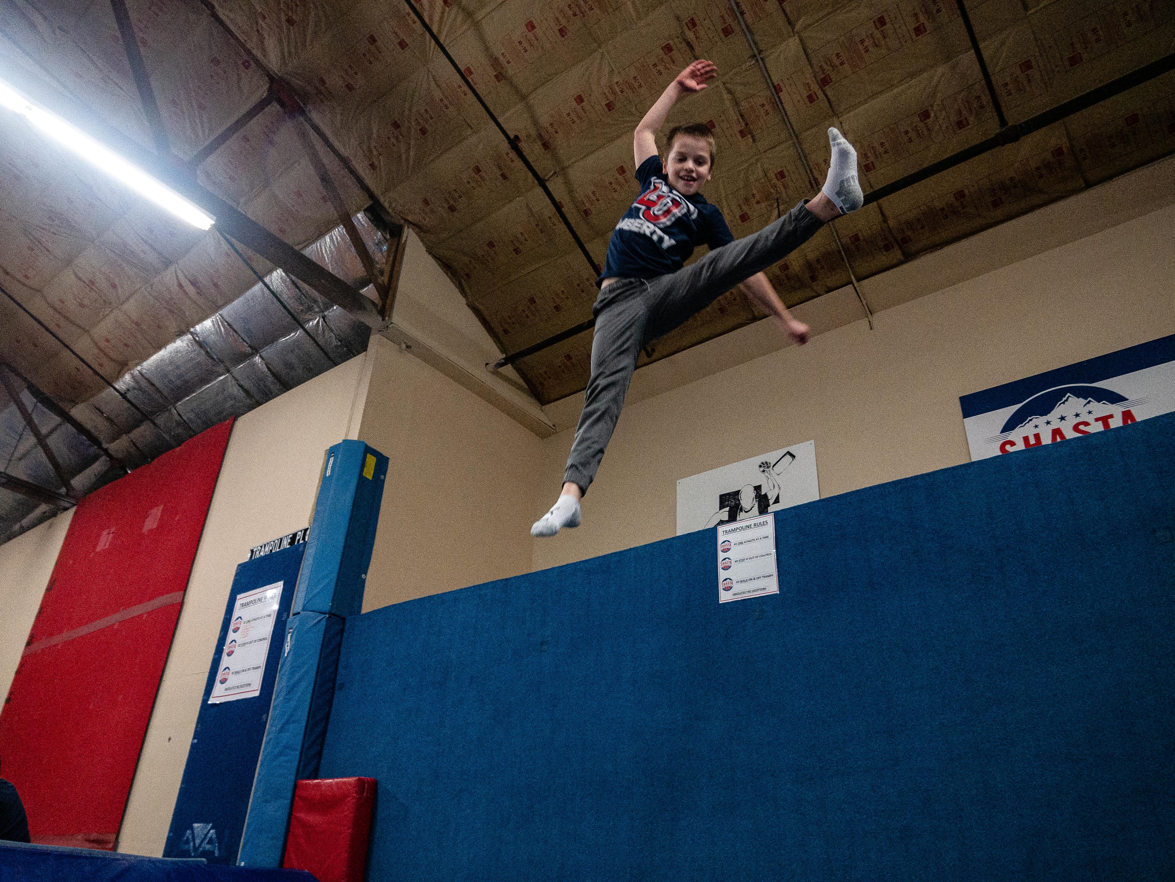 Athlete performing a flying kick on trampoline